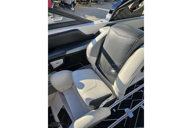 Slide: The Image of 2015 Nautique Super Air Nautique G23 interior seat, featuring sleek black and white design. - 86