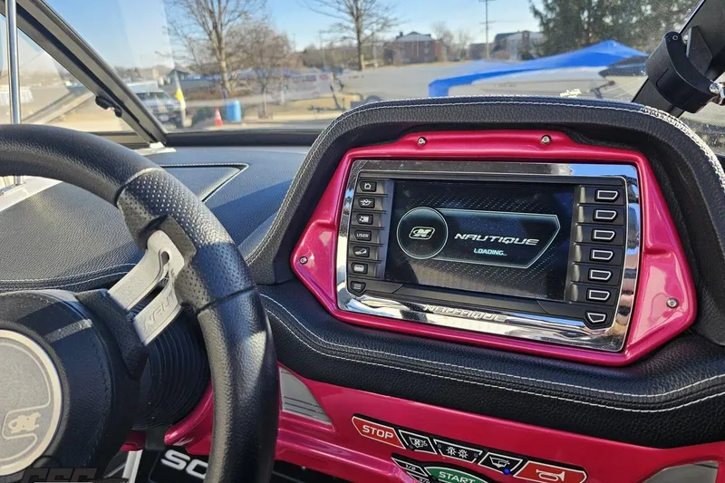 Slide: The Image of 2015 Nautique Super Air Nautique G23 dashboard with steering wheel and digital display. - 90