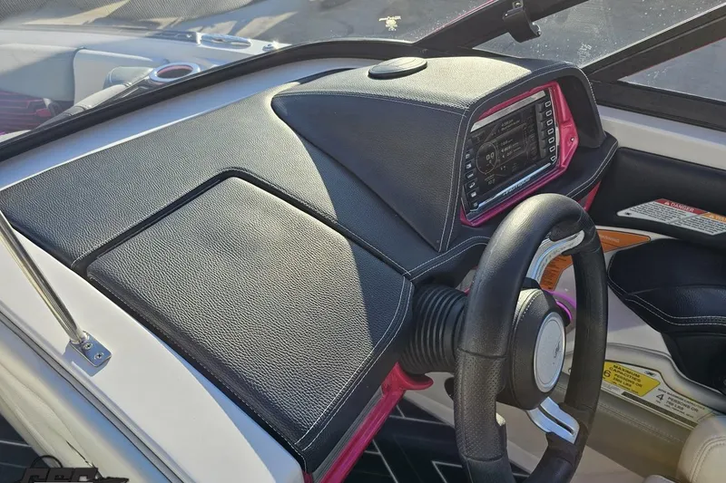 Slide: The Image of 2015 Nautique Super Air Nautique G23 dashboard with steering wheel and control panel. - 95