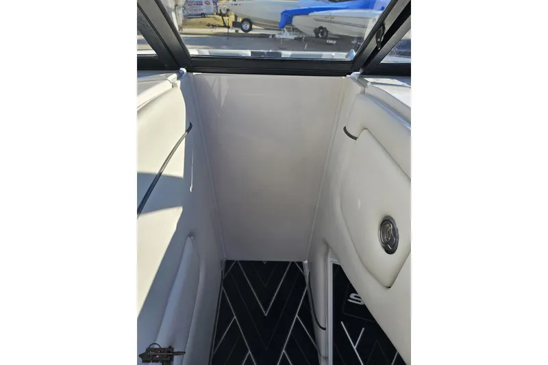 Slide: The Image of Interior view of 2015 Nautique Super Air Nautique G23 boat, featuring white upholstery and black flooring. - 98