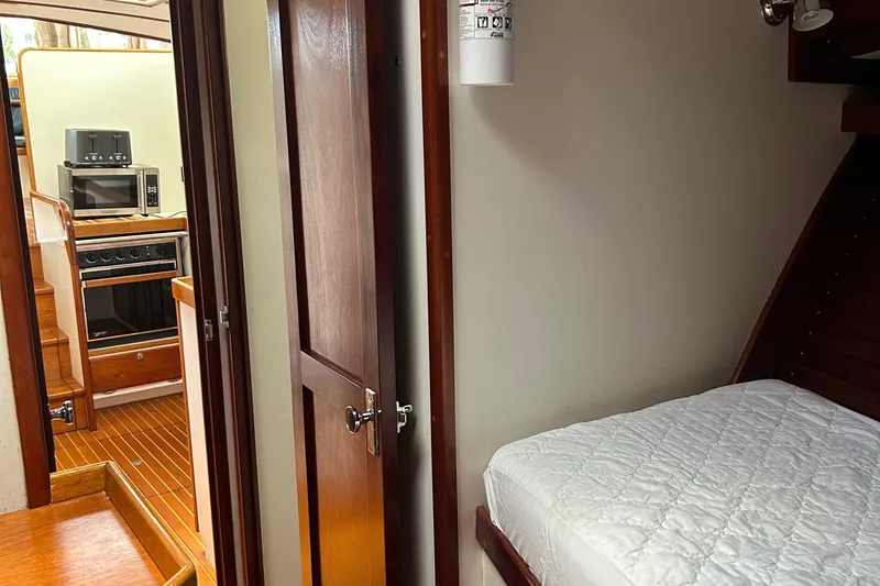 Slide: The Image of Interior of 1987 Lyman-Morse Downeast Flybridge, featuring cozy cabin and kitchen area. - 20