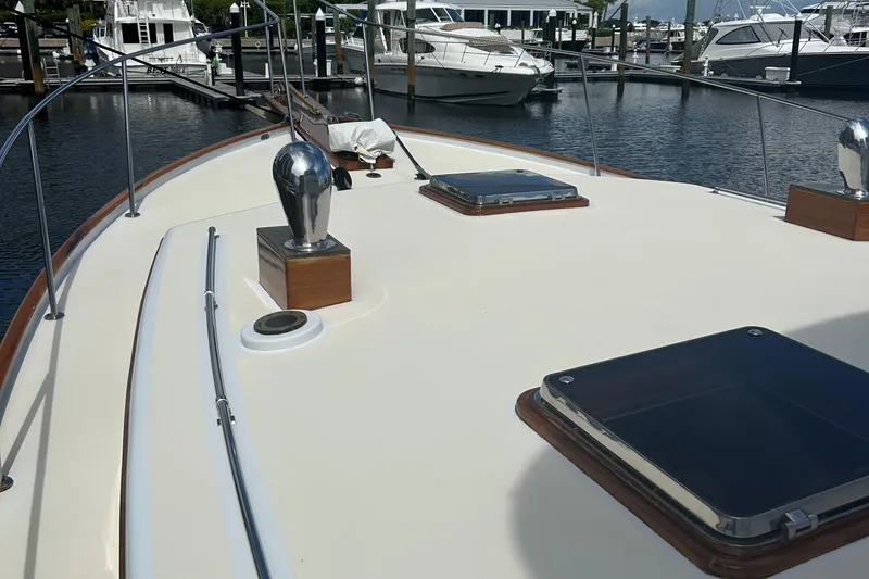 Slide: The Image of 1987 Lyman-Morse Downeast Flybridge yacht deck at marina with other boats. - 24