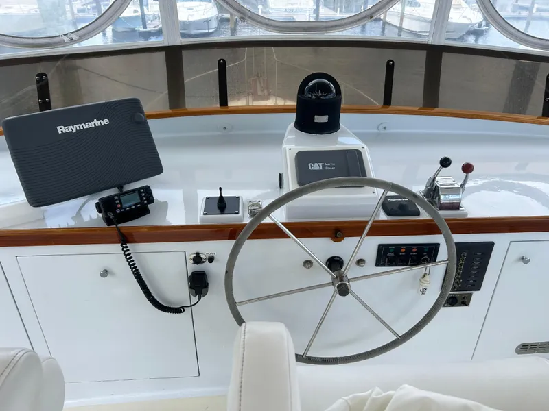 Slide: The Image of 1987 Lyman-Morse Downeast Flybridge helm with Raymarine navigation and classic steering wheel. - 33
