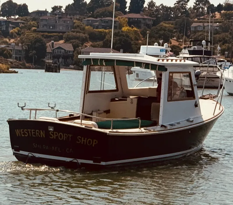 Slide: The Image of 1974 Dyer 29' Sport Fisher boat on water, labeled "Western Sport Shop." - 1