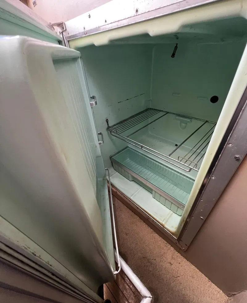 Slide: The Image of Open refrigerator inside a 1974 Dyer 29' Sport Fisher boat. - 28