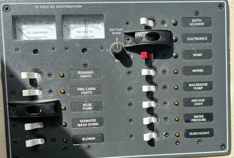 Slide: The Image of Control panel of a 1974 Dyer 29' Sport Fisher boat with various switches and gauges. - 32