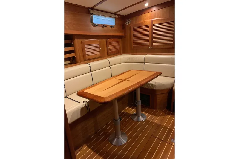 Slide: The Image of Interior of 2006 Sabre 38 Hard Top Express with wooden table and cushioned seating. - 10