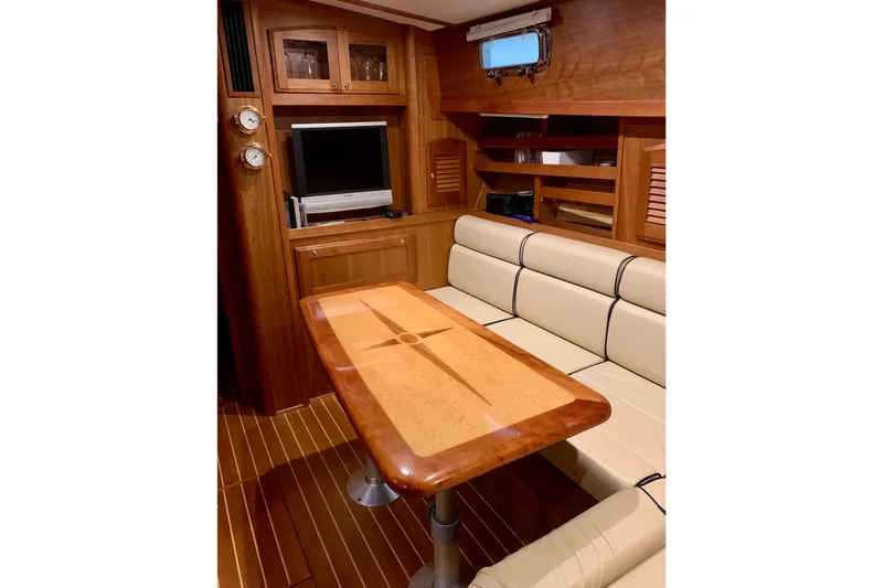 Slide: The Image of Interior of 2006 Sabre 38 Hard Top Express yacht with wood finishes and seating area. - 12