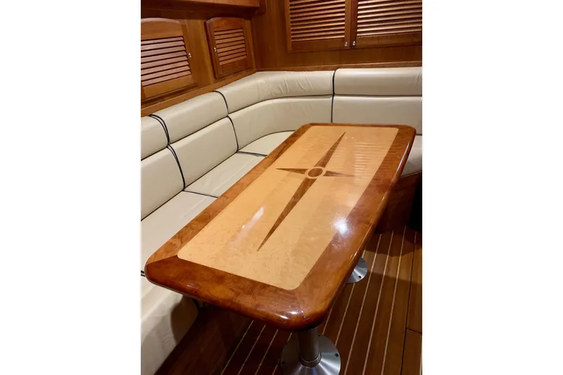 Slide: The Image of Elegant interior of 2006 Sabre 38 Hard Top Express with wooden table and cushioned seating. - 13