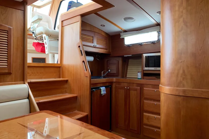 Slide: The Image of Interior of 2006 Sabre 38 Hard Top Express yacht with wooden cabinetry and stairs. - 14