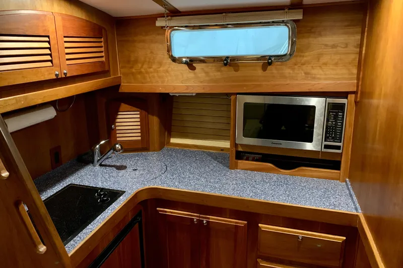 Slide: The Image of 2006 Sabre 38 Hard Top Express galley with wood cabinetry and modern appliances. - 17