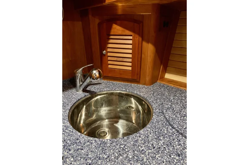 Slide: The Image of 2006 Sabre 38 Hard Top Express yacht interior with stainless steel sink and wooden cabinetry. - 19