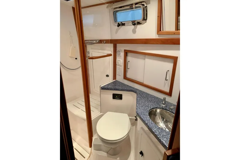Slide: The Image of 2006 Sabre 38 Hard Top Express yacht bathroom with shower, sink, and toilet. - 22