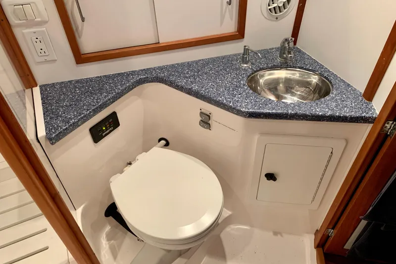Slide: The Image of 2006 Sabre 38 Hard Top Express bathroom with modern sink and toilet. - 23