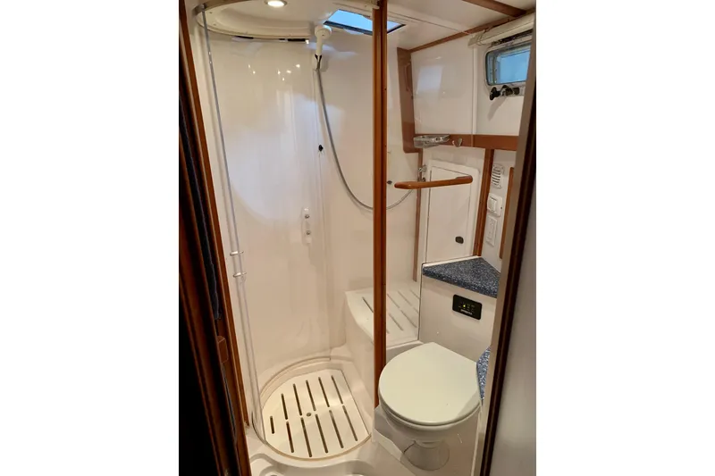 Slide: The Image of 2006 Sabre 38 Hard Top Express bathroom with shower, toilet, and compact design. - 24