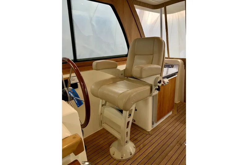 Slide: The Image of Captain's chair on 2006 Sabre 38 Hard Top Express yacht, featuring teak flooring and elegant design. - 26