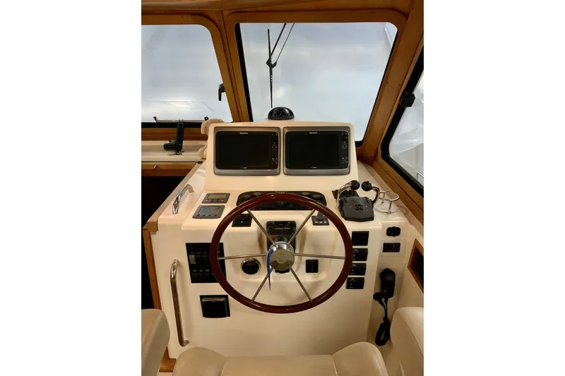 Slide: The Image of 2006 Sabre 38 Hard Top Express helm with dual screens and wooden steering wheel. - 27