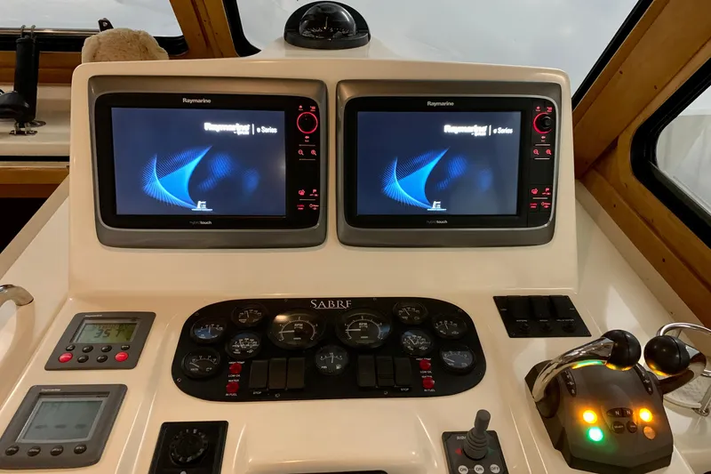 Slide: The Image of Control panel of 2006 Sabre 38 Hard Top Express with dual Raymarine displays. - 28