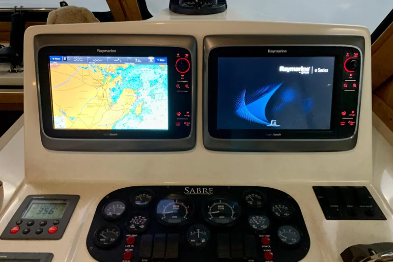 Slide: The Image of Helm of 2006 Sabre 38 Hard Top Express with Raymarine navigation displays. - 29