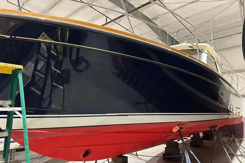 Slide: The Image of 2006 Sabre 38 Hard Top Express boat in a workshop, elevated on supports. - 3