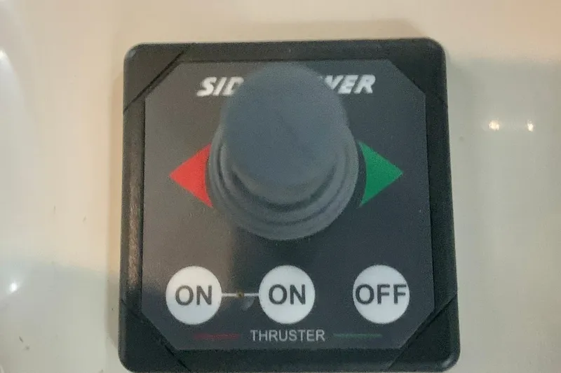 Slide: The Image of 2006 Sabre 38 Hard Top Express thruster control panel with joystick and on/off buttons. - 33