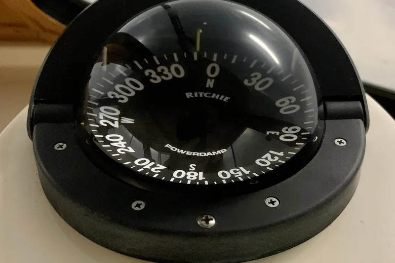Slide: The Image of Compass on 2006 Sabre 38 Hard Top Express boat, displaying cardinal directions. - 34