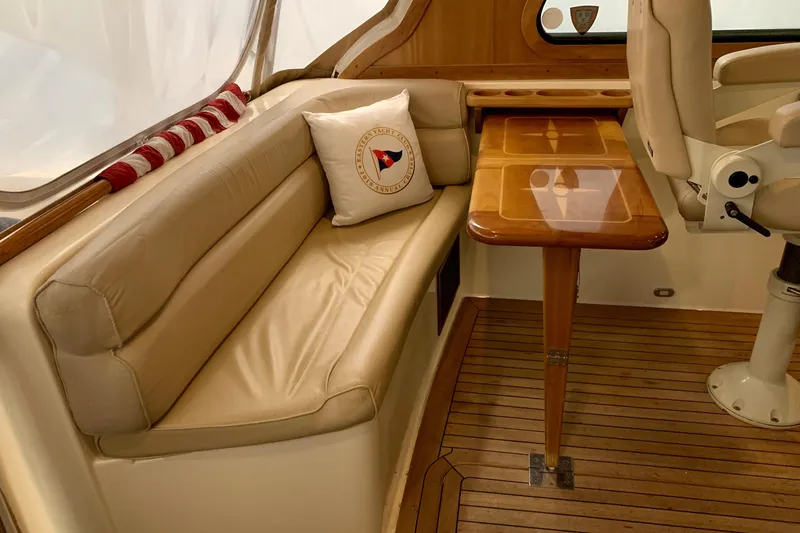 Slide: The Image of 2006 Sabre 38 Hard Top Express interior with beige seating and wooden table. - 36