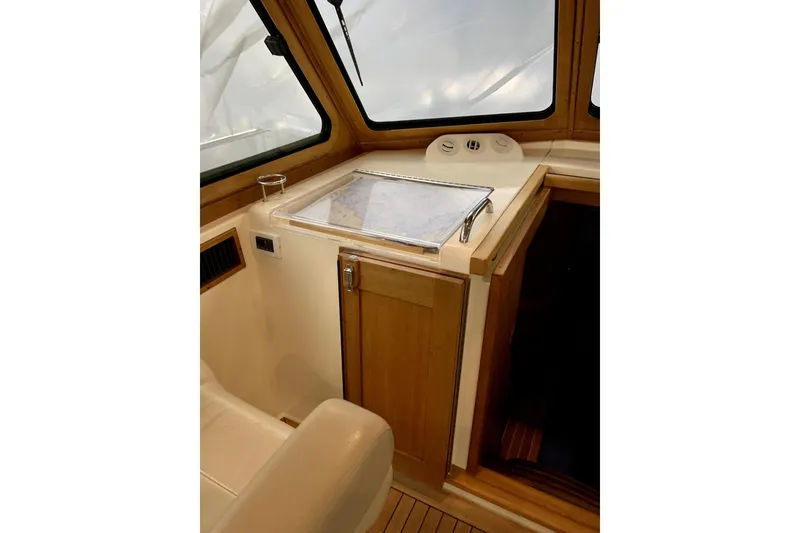 Slide: The Image of 2006 Sabre 38 Hard Top Express interior with navigation station and wooden cabinetry. - 39