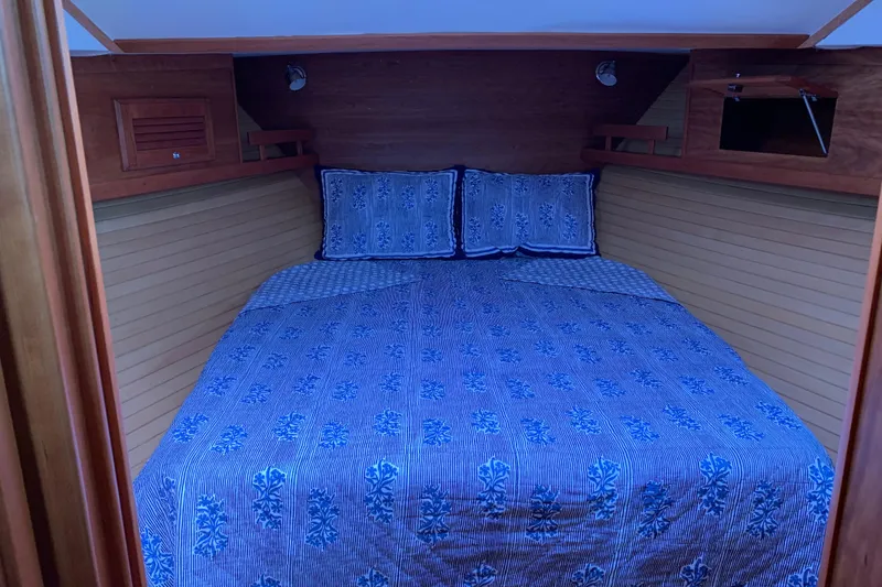 Slide: The Image of Cozy cabin interior of 2006 Sabre 38 Hard Top Express with blue bedding. - 4