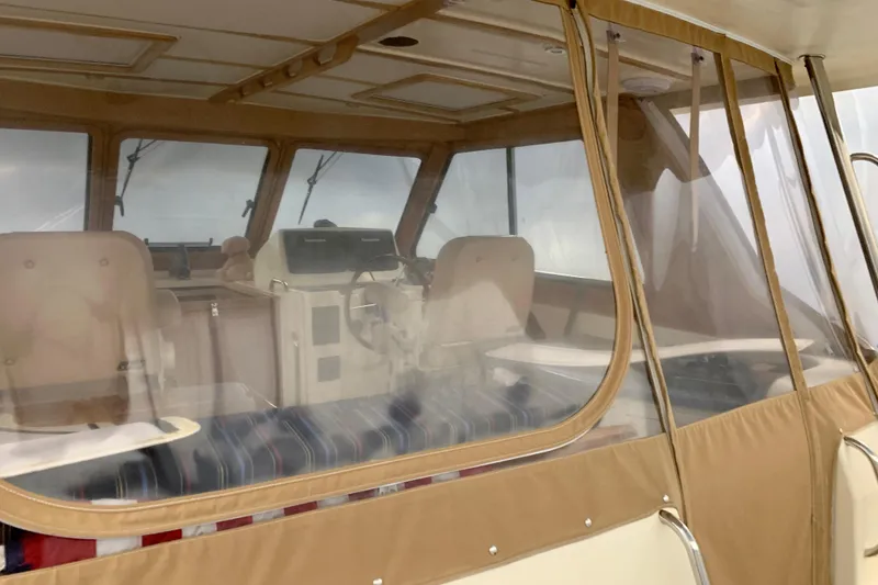 Slide: The Image of 2006 Sabre 38 Hard Top Express interior with beige seating and helm. - 40