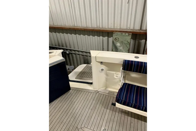 Slide: The Image of 2006 Sabre 38 Hard Top Express boat interior with striped seating and wooden flooring. - 44