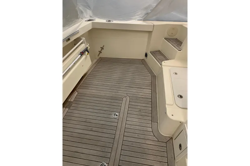 Slide: The Image of 2006 Sabre 38 Hard Top Express boat deck with teak flooring and seating area. - 46