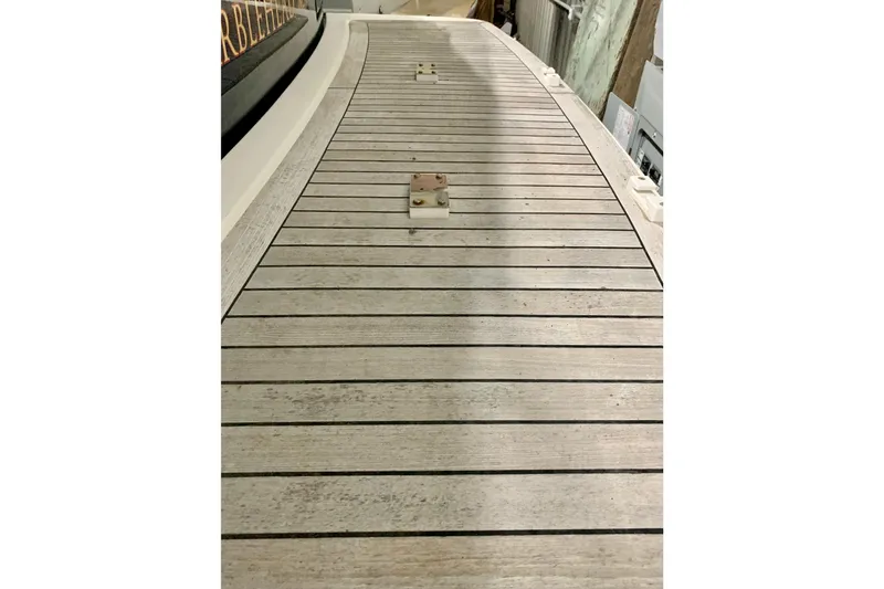 Slide: The Image of Teak deck of 2006 Sabre 38 Hard Top Express boat, showcasing elegant wood finish. - 55