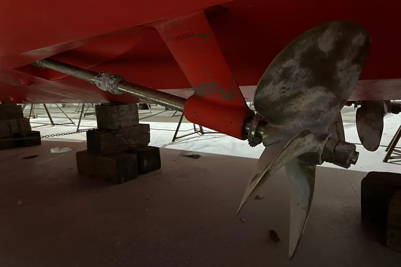 Slide: The Image of Propeller of 2006 Sabre 38 Hard Top Express on dry dock, supported by wooden blocks. - 56