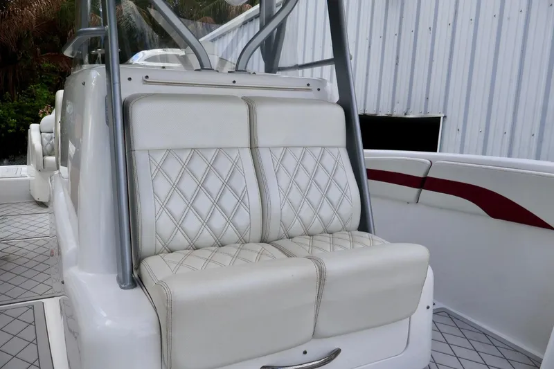 Slide: The Image of 2015 Deep Impact 33 boat with white diamond-stitched seating and sleek design. - 10
