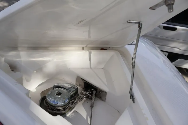 Slide: The Image of Anchor compartment of 2015 Deep Impact 33 boat, featuring chain and winch mechanism. - 14