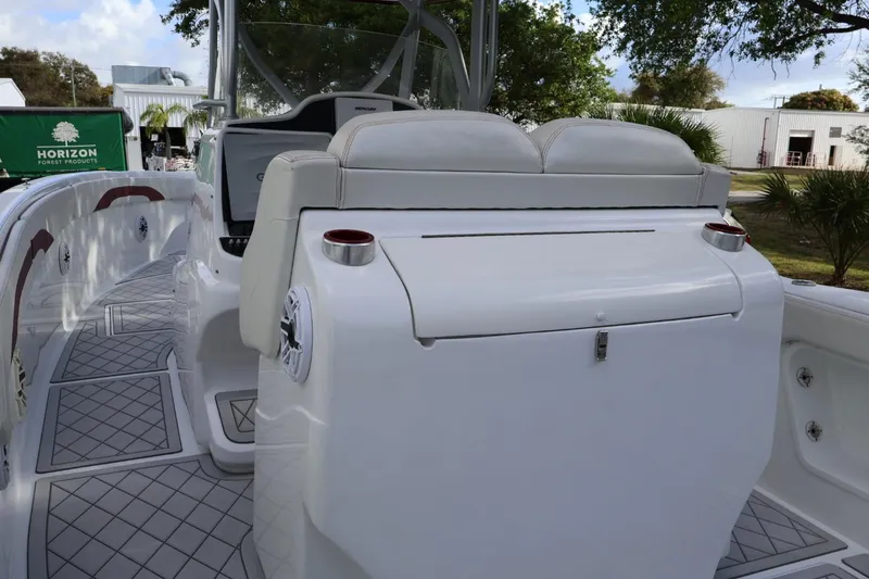 Slide: The Image of 2015 Deep Impact 33 boat interior with seating and cup holders, showcasing luxury design. - 5