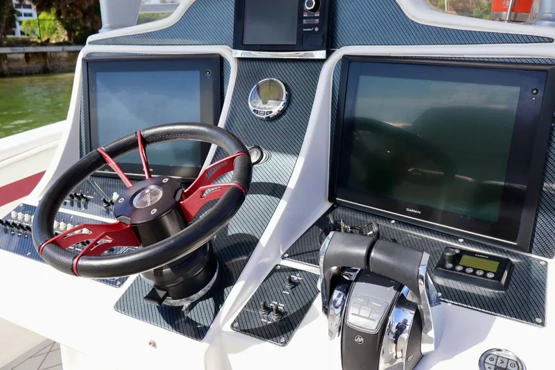Slide: The Image of Steering console of 2015 Deep Impact 33 boat with dual Garmin displays. - 8