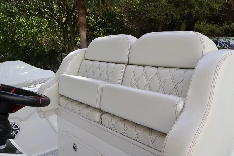 Slide: The Image of Luxurious seating on a 2015 Deep Impact 33 boat, featuring elegant white upholstery. - 9