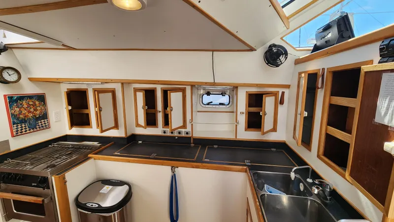 Slide: The Image of Interior of 2004 Dudley Dix Jacobs Bros 43 Pilot yacht kitchen with wooden cabinets and appliances. - 31