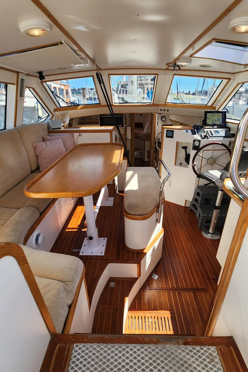 Slide: The Image of 2004 Dudley Dix Jacobs Bros 43 Pilot boat interior with wood flooring and seating area. - 21