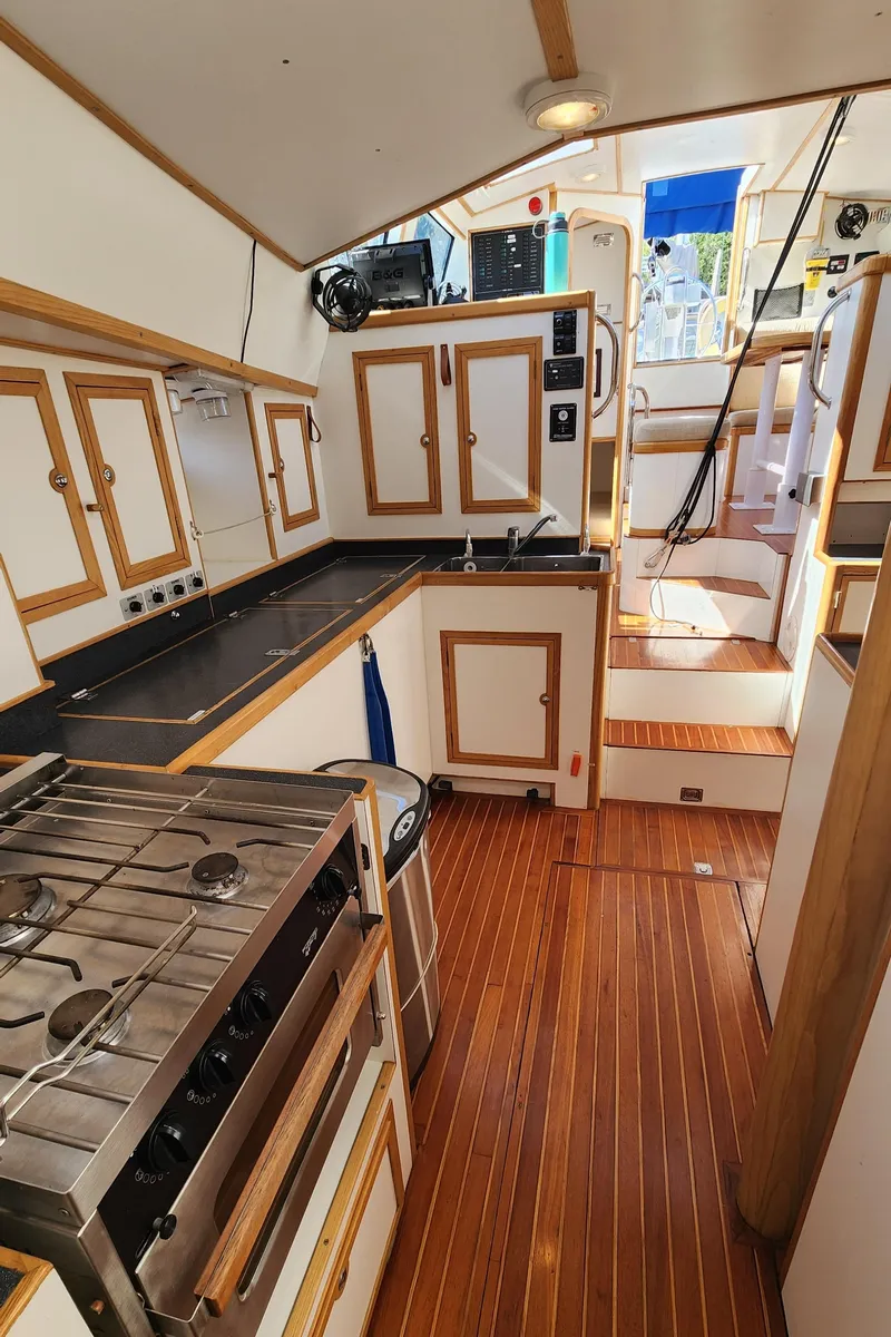 Slide: The Image of Interior of 2004 Dudley Dix Jacobs Bros 43 Pilot yacht with wooden cabinetry and modern kitchen. - 48