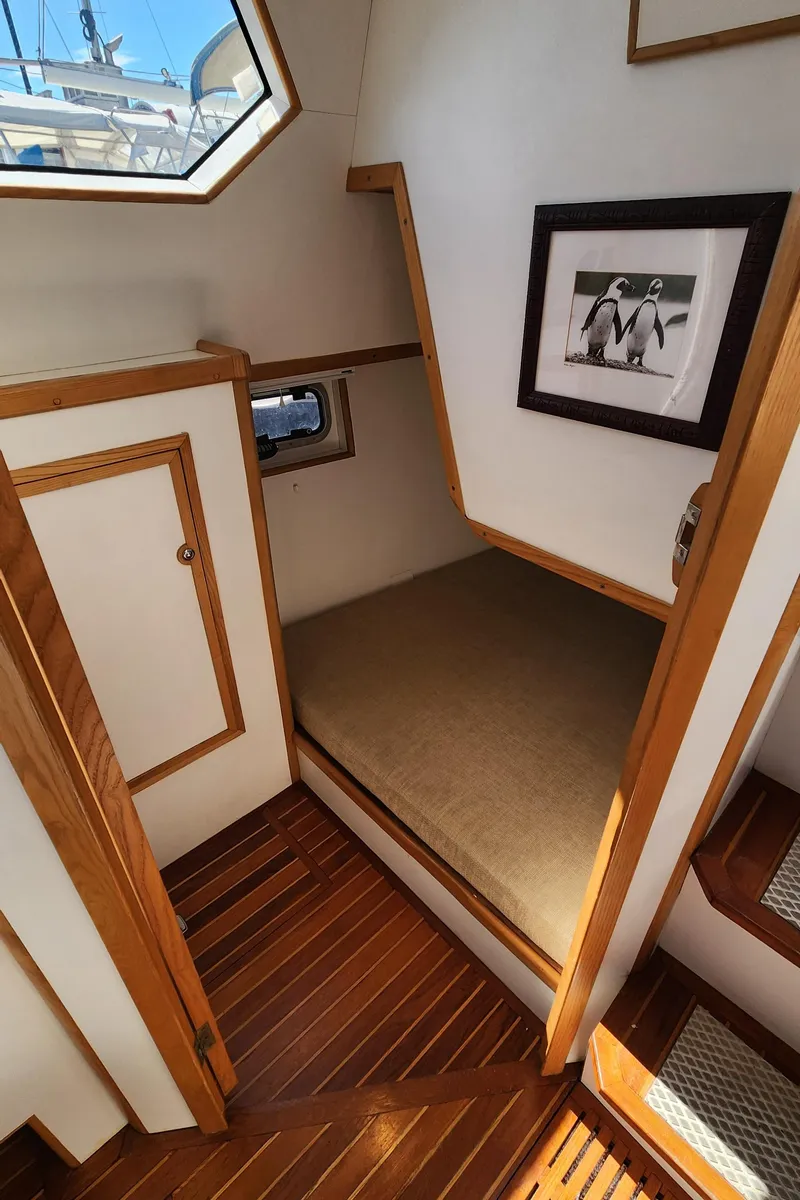 Slide: The Image of Cozy cabin interior of 2004 Dudley Dix Jacobs Bros 43 Pilot with wooden accents and framed artwork. - 23