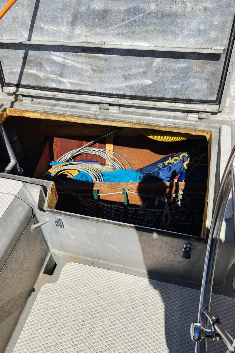 Slide: The Image of Open storage compartment on 2004 Dudley Dix Jacobs Bros 43 Pilot boat, containing colorful ropes and equipment. - 20