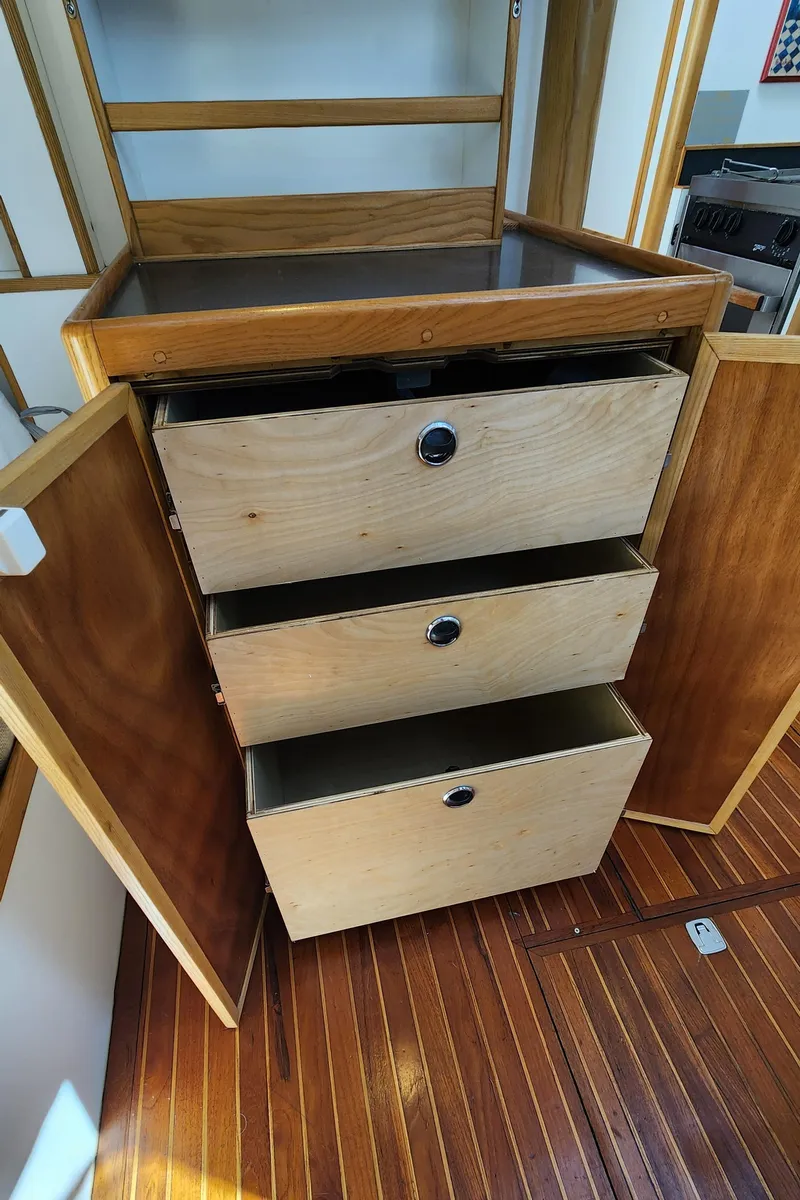 Slide: The Image of Wooden cabinet with three open drawers on a Dudley Dix Jacobs Bros 43 Pilot, 2004 model. - 36