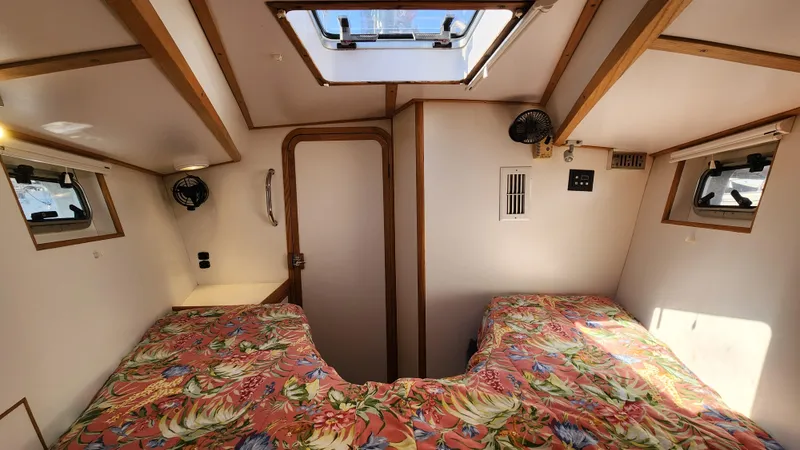 Slide: The Image of Cozy cabin interior of 2004 Dudley Dix Jacobs Bros 43 Pilot with twin beds and floral bedding. - 45