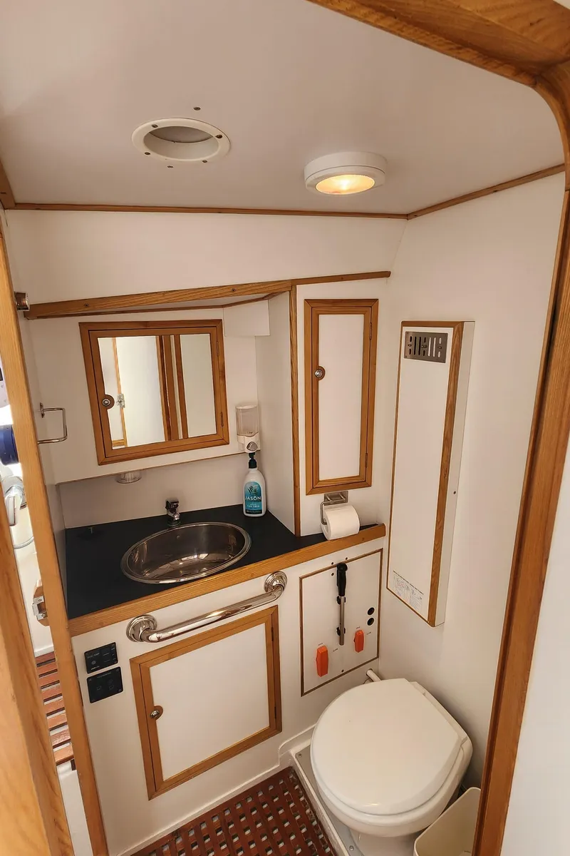 Slide: The Image of Compact bathroom in a 2004 Dudley Dix Jacobs Bros 43 Pilot yacht, featuring sink and toilet. - 42