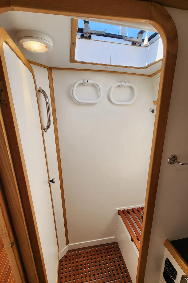 Slide: The Image of 2004 Dudley Dix Jacobs Bros 43 Pilot yacht interior with wooden trim and skylight. - 43