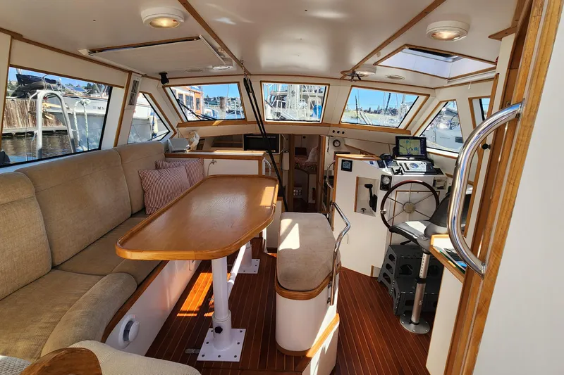 Slide: The Image of Interior of 2004 Dudley Dix Jacobs Bros 43 Pilot boat, featuring helm, seating, and navigation equipment. - 22