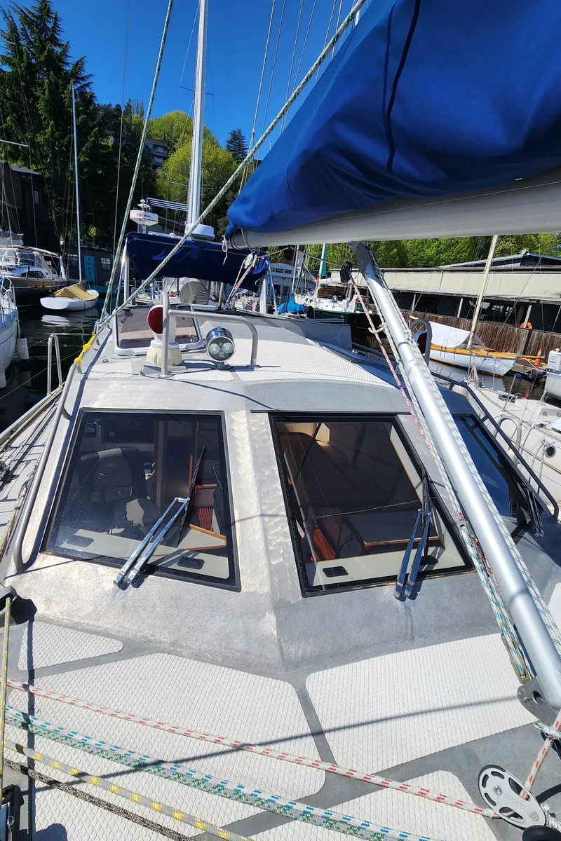Slide: The Image of 2004 Dudley Dix Jacobs Bros 43 Pilot sailboat with blue sail cover, docked in marina. - 14